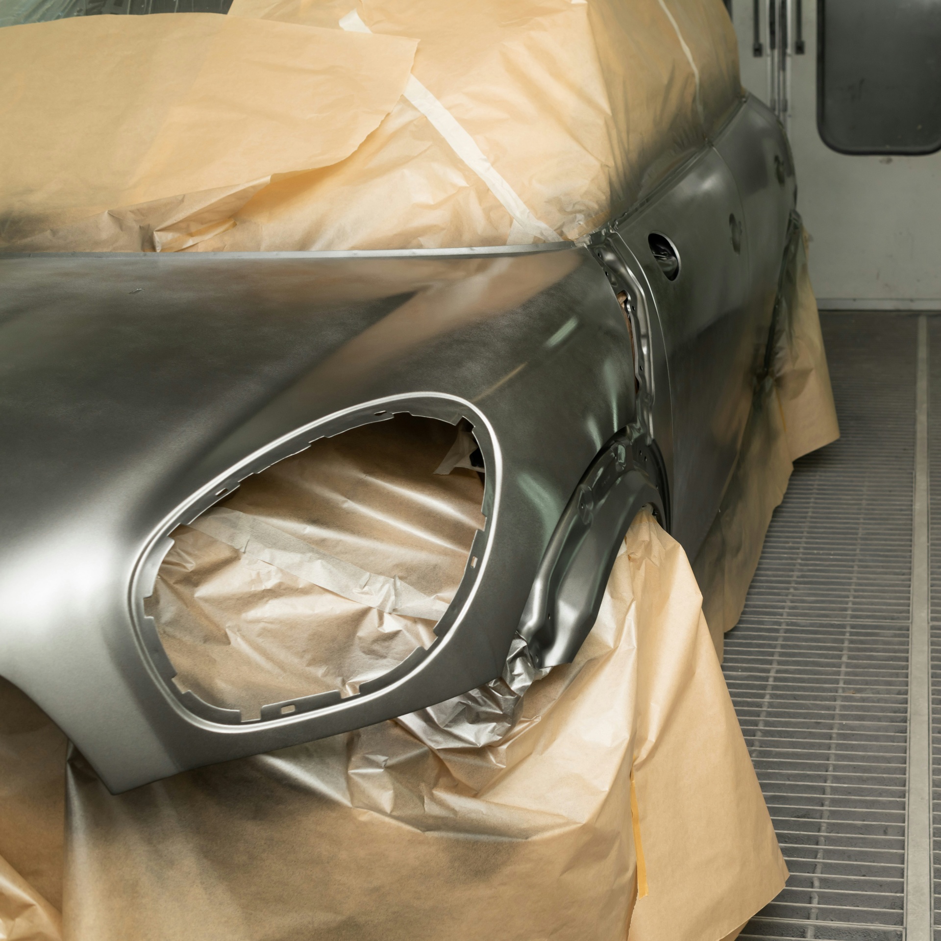 Masked car panel prepped for base coat spray painting in Mega Body Auto's Cape Town spray booth