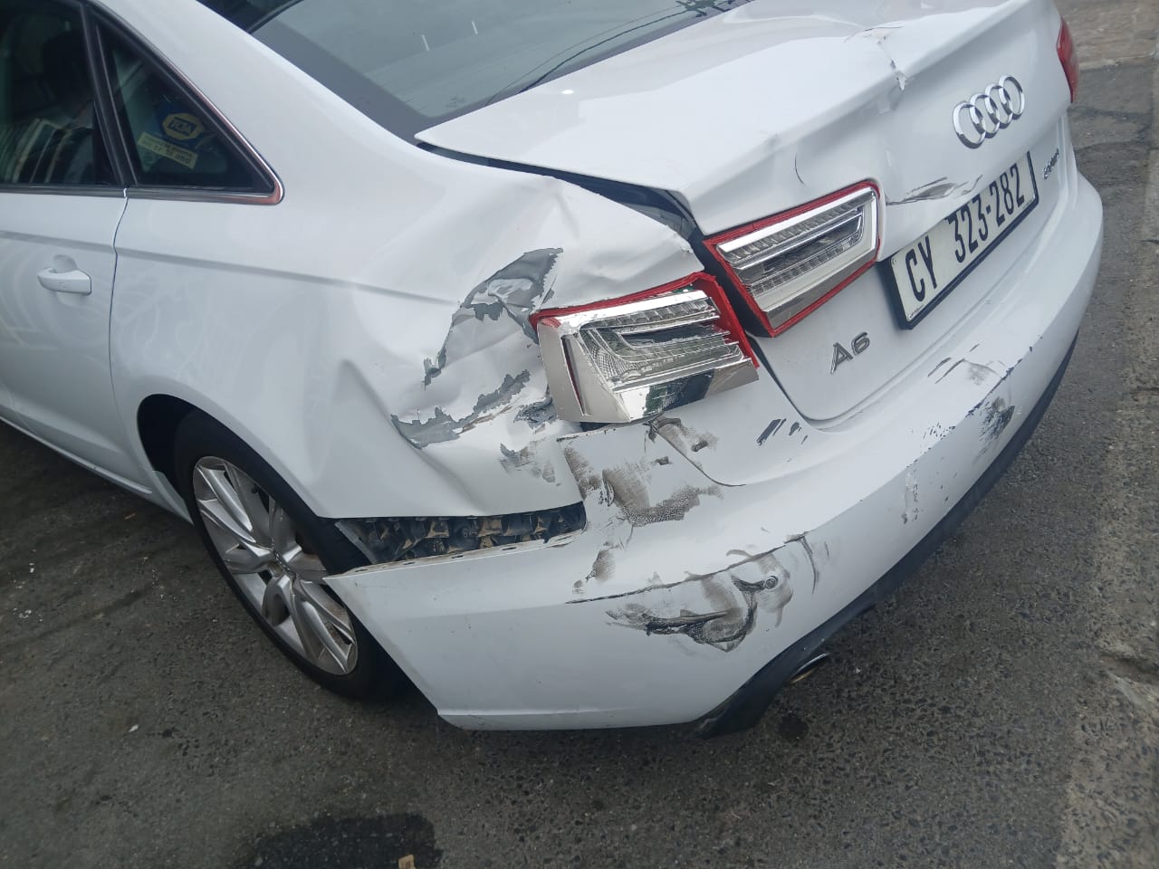 White Audi A6 rear quarter panel and bumper with accident damage, before repair at Mega Body Auto Maitland