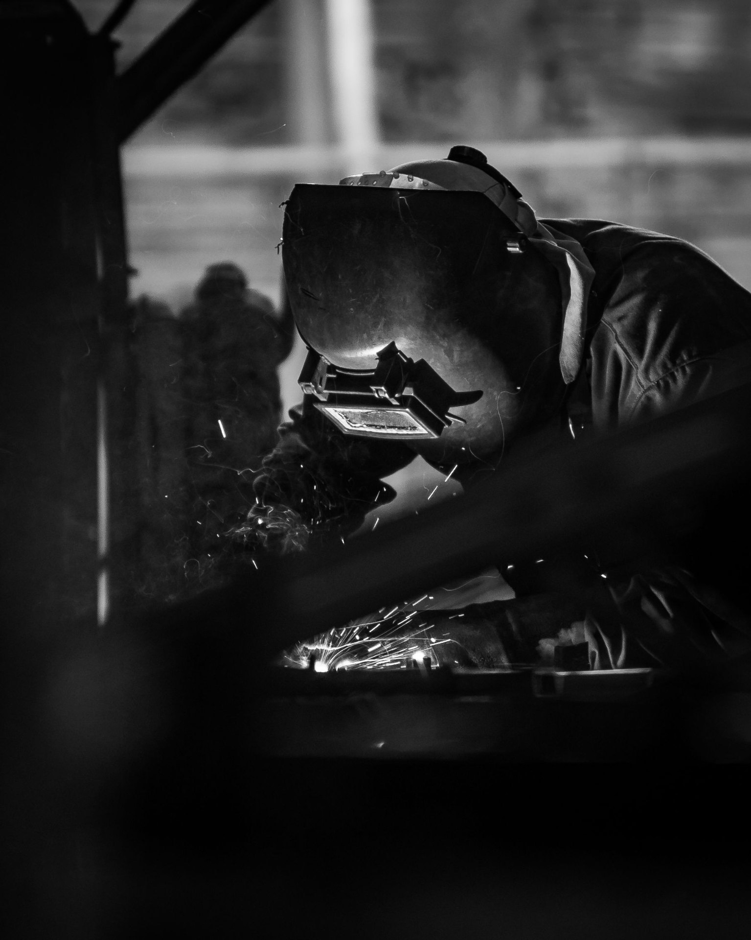 Panel beater welding and reshaping a damaged vehicle body panel during metal repair work at Mega Body Auto Maitland, Cape Town