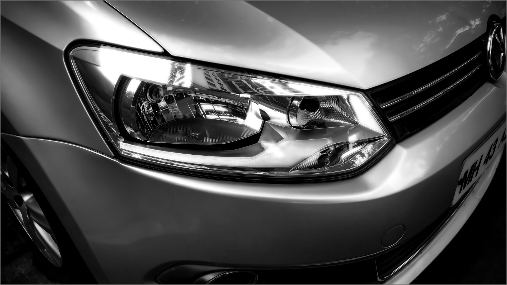 Close-up detail of a polished VW headlight and silver bodywork during classic car restoration at Mega Body Auto Cape Town